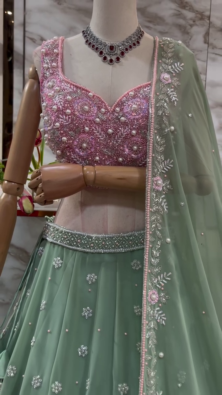 Pastel Green Net Embroidered Lehenga Choli with Intricately Hand-Embellished Pink Sequins Work Blouse and Matching Floral Border Dupatta – Perfect for Wedding, Sangeet, or Festive Occasions
