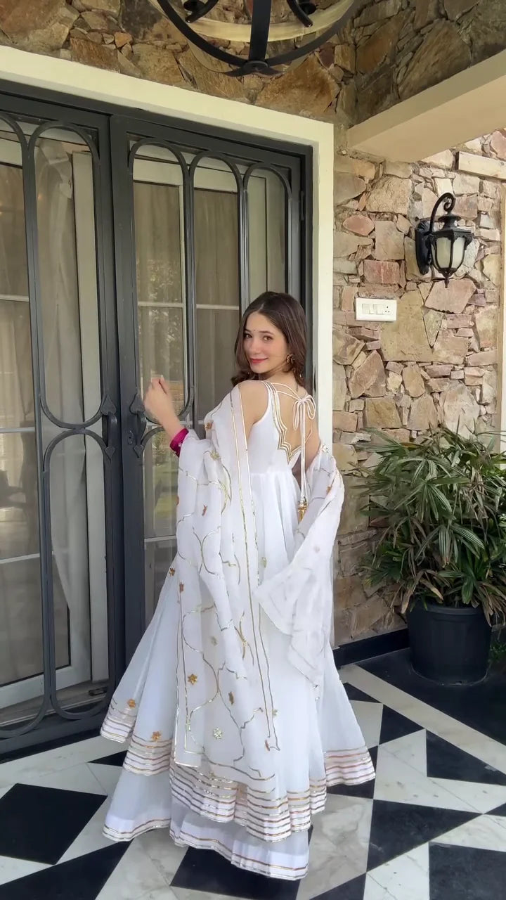 White Anarkali Dress with Intricate Gold Floral Embroidery and Delicate Sequin Work – Featuring a Flowing Skirt, V-neckline, and Matching Dupatta