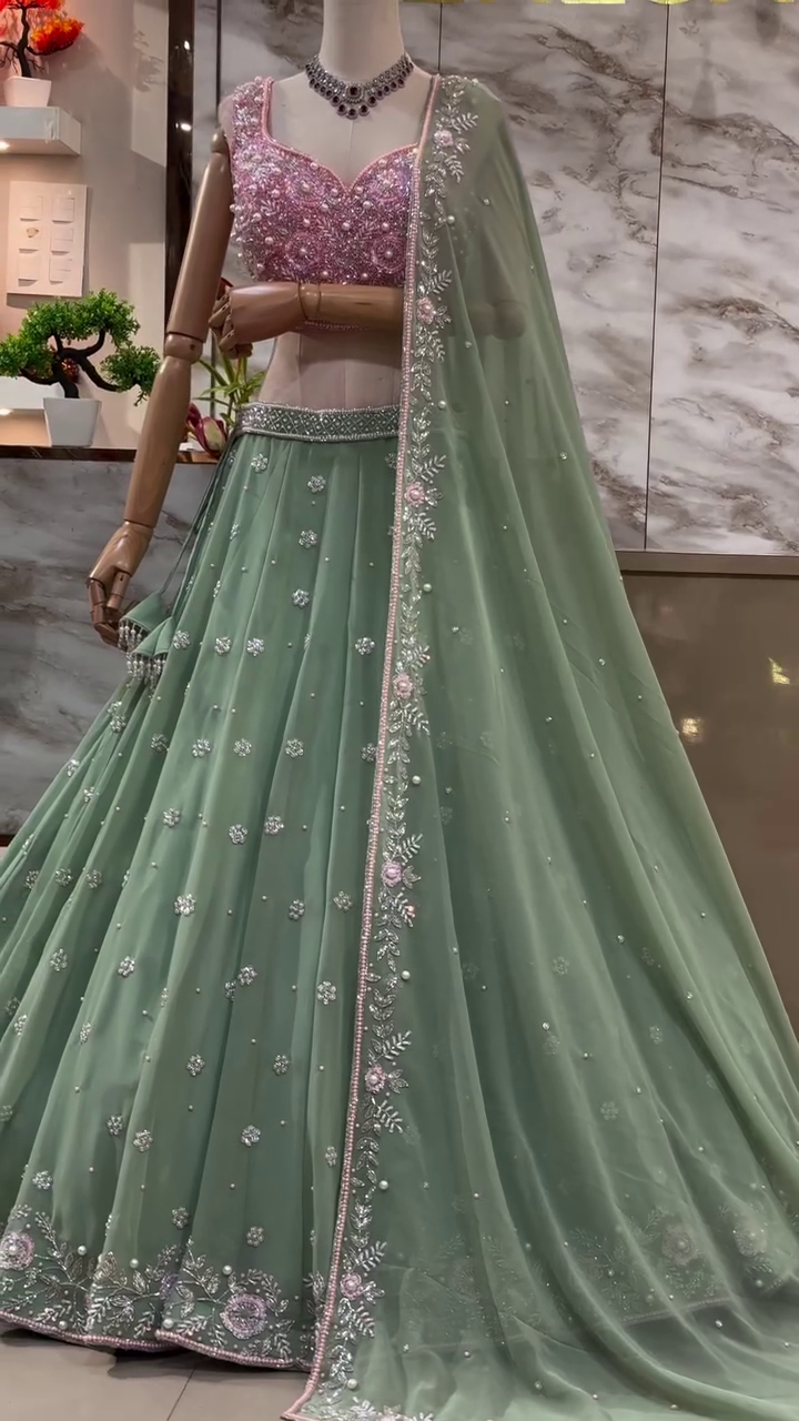 Pastel Green Net Embroidered Lehenga Choli with Intricately Hand-Embellished Pink Sequins Work Blouse and Matching Floral Border Dupatta – Perfect for Wedding, Sangeet, or Festive Occasions
