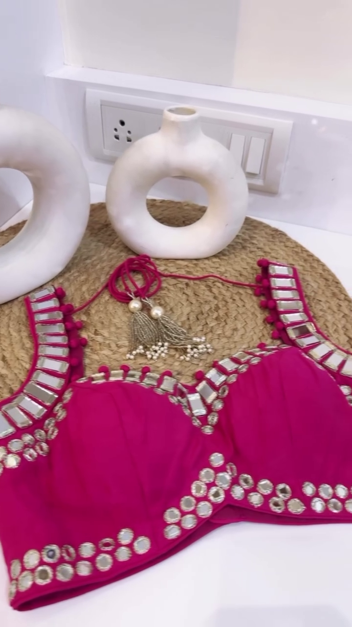 Rani Pink Mirror Work Lehenga Choli Set Featuring a Sleeveless Embellished Blouse with Tie-Up Back, Paired with a Flared Embroidered Lehenga and Soft Tie-Dye Dupatta with Mirror Border – Ideal for Mehendi, Haldi, or Festive Celebrations