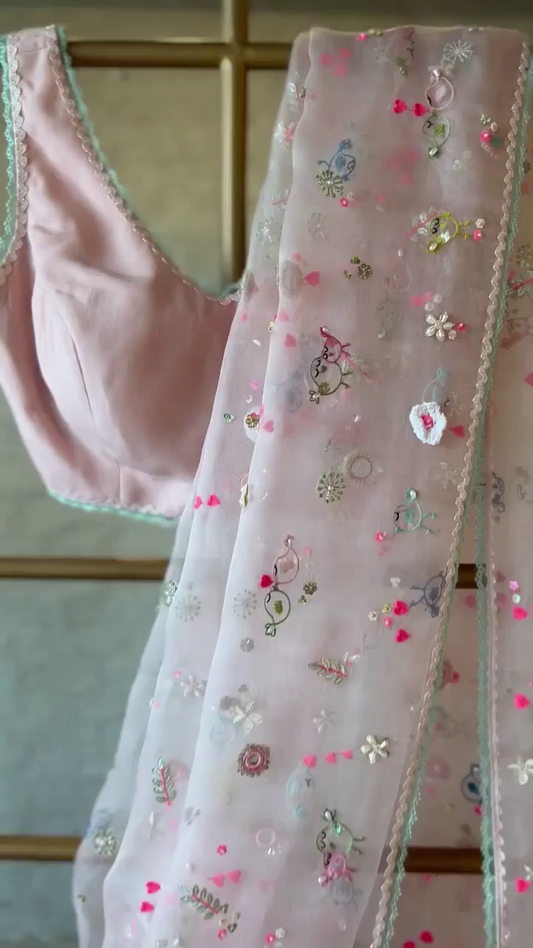 Soft Blush Pink Organza Saree and Sleeveless Blouse Set with Intricate Multicolor Floral Embroidery, Mirror Work, and Delicate Lace Trim for Elegant Festive or Ethnic Wear