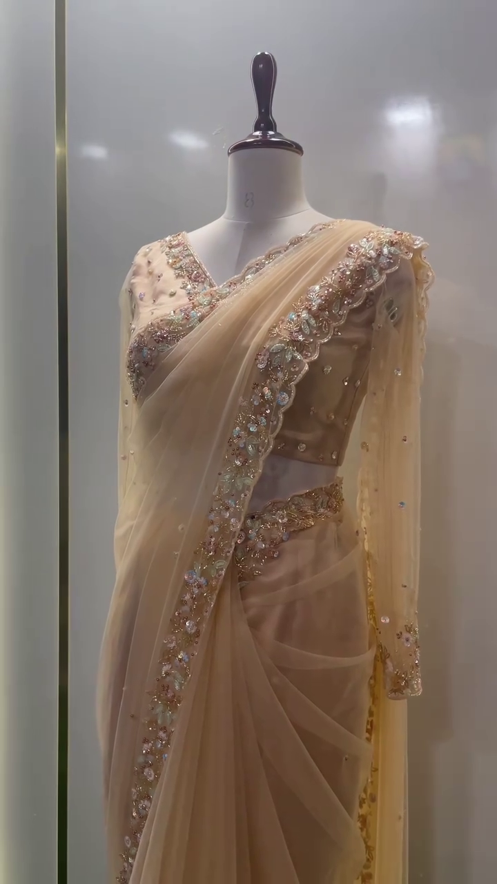 Peach Net Saree with Intricately Embellished Sequin and Pearl Border, Matching Handcrafted Blouse, and Delicate Stone Work – Ideal for Reception, Cocktail Party, or Grand Celebrations