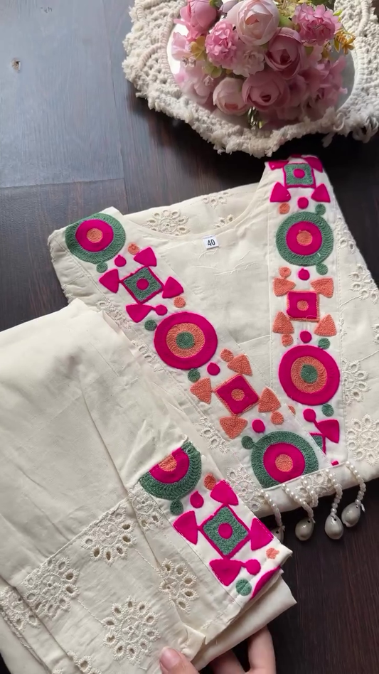 Off-White Cotton Kurti Set with Colorful Mirror-Inspired Thread Embroidery and Cutwork Detailing, Featuring V-Neckline Accents, Three-Quarter Sleeves, and Matching Pants with Coordinated Embellishments – Perfect for Casual and Festive Wear
