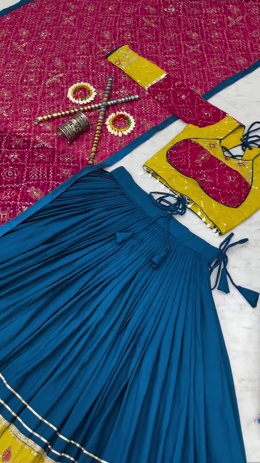 Traditional Navratri Chaniya Choli Set with Blue Pleated Lehenga, Yellow and Pink Embroidered Blouse, Bandhani Dupatta, and Matching Accessories for Garba and Festive Wear