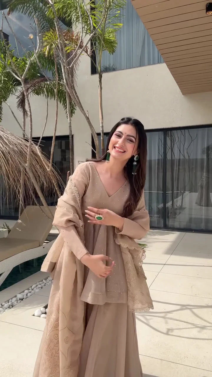 Beige Peplum Style Anarkali Dress with Flared Pants – Featuring Intricate Embroidery and a Sheer Dupatta with Scalloped Edges, Perfect for Weddings