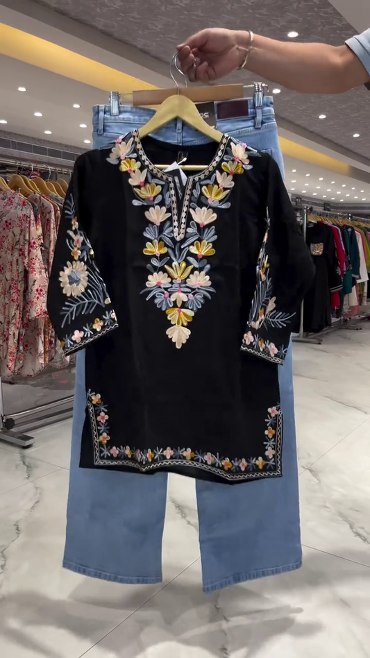 Black Short Kurti with Multicolor Floral Thread Embroidery on Neckline, Sleeves, and Hemline Paired with Light Blue Straight Denim Jeans – A Perfect Blend of Ethnic and Casual for Daily and Semi-Festive Wear