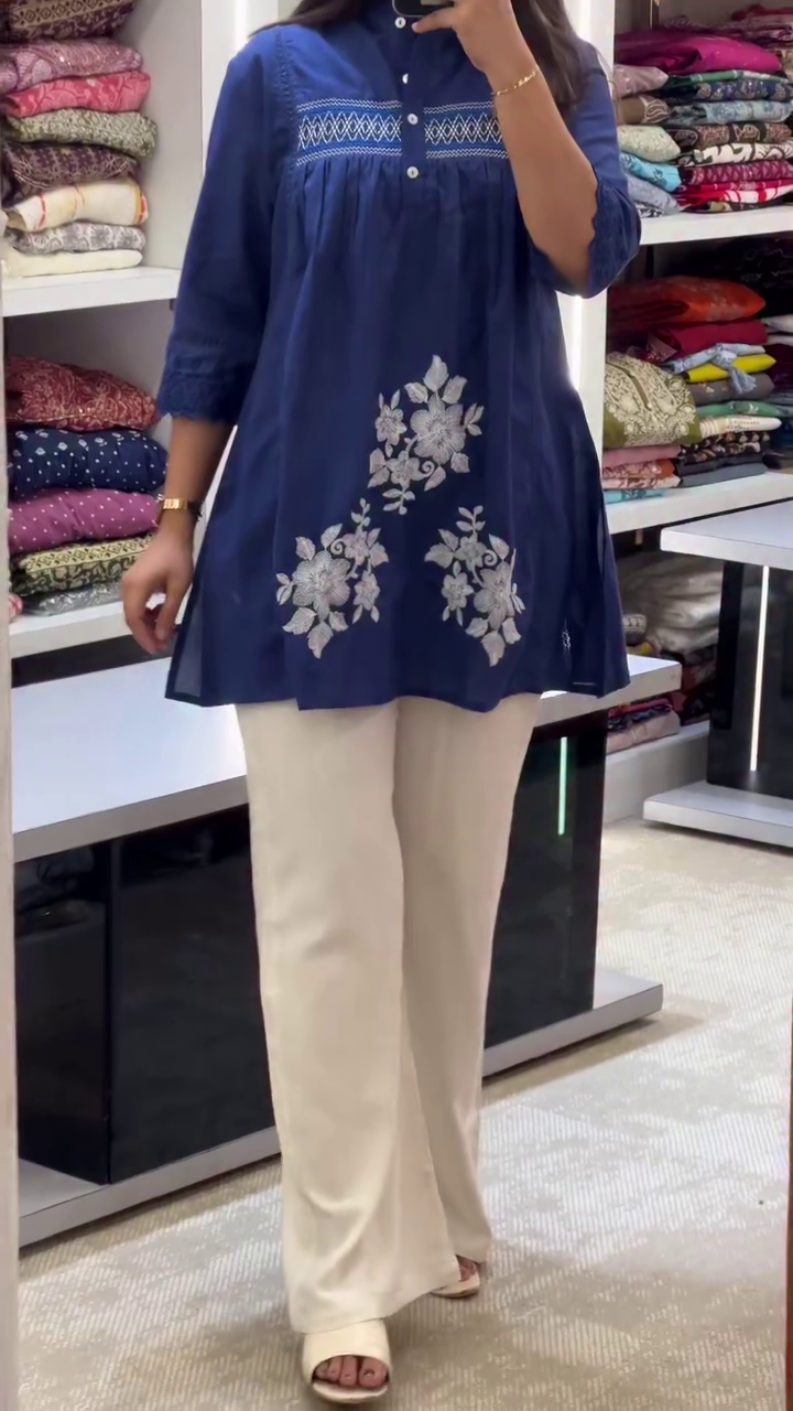 Stylish Navy Blue Short Kurti with Intricate White Floral Embroidery and Pintuck Detailing on Yoke Paired with Elegant Off-White Flared Pants – Perfect for Office Wear, Casual Outings, and Semi-Formal Events