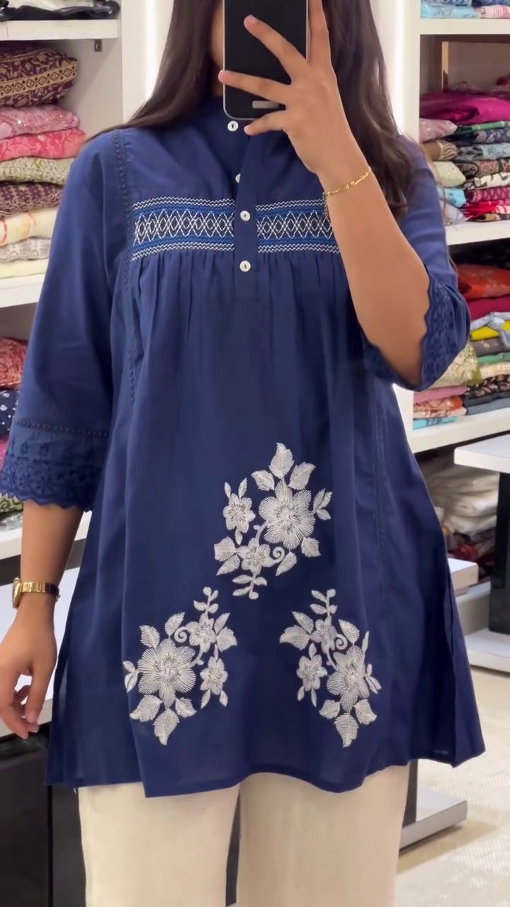 Stylish Navy Blue Short Kurti with Intricate White Floral Embroidery and Pintuck Detailing on Yoke Paired with Elegant Off-White Flared Pants – Perfect for Office Wear, Casual Outings, and Semi-Formal Events