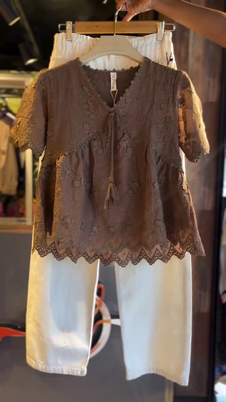 Brown Floral Embroidered Lace Peplum Top with Tassel Tie-Up and Scalloped Hem Paired with White Straight Pants – Stylish Casual and Semi-Formal Outfit for Women